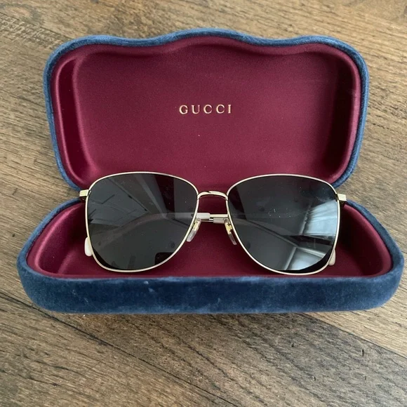 Gucci Gold and Black Sunglasses with Red Case Gucci GG1221S Sunglasses Gold/Black at CareOfCarl.com main image 3